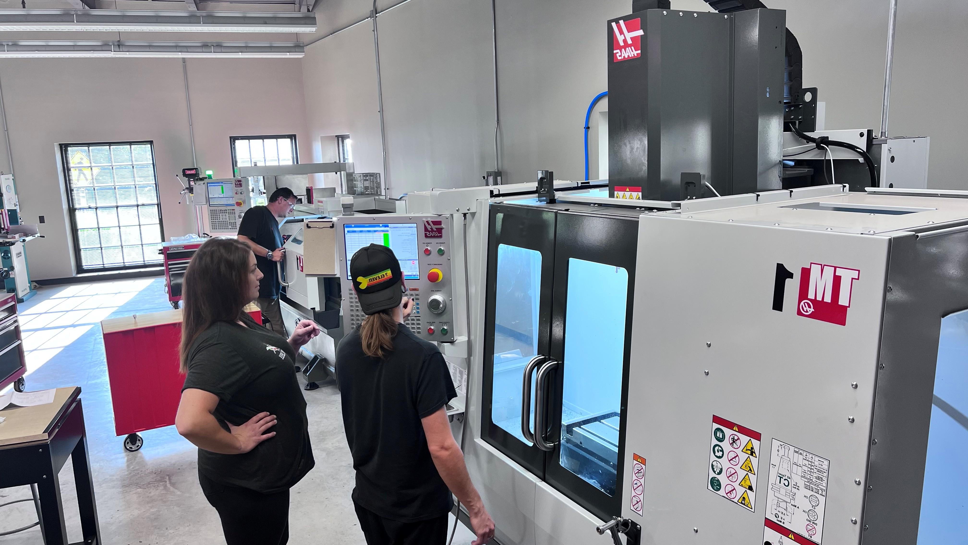 Students operating a CNC machine