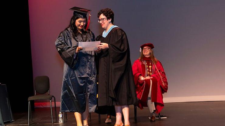 graduate receives award from Program Manager Michelle Kulla